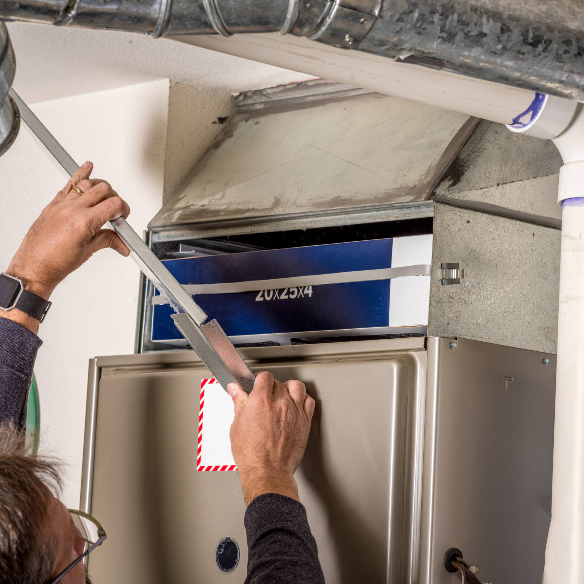 Handyman Removes Furnace Pannel Cover